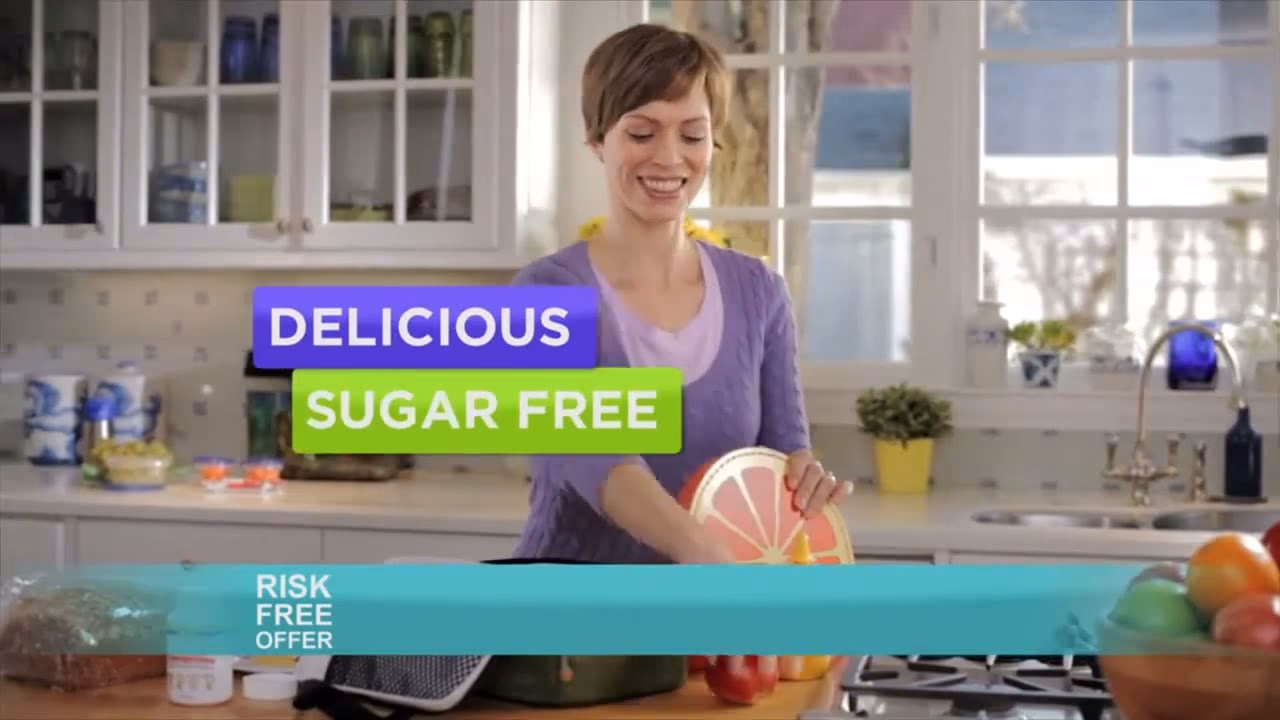 A mom in the kitchen with the Delicious Sugar Free banner