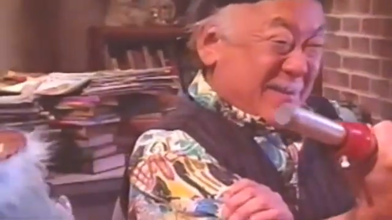 Pat Morita speaking into a microphone on the KangaRoddy set