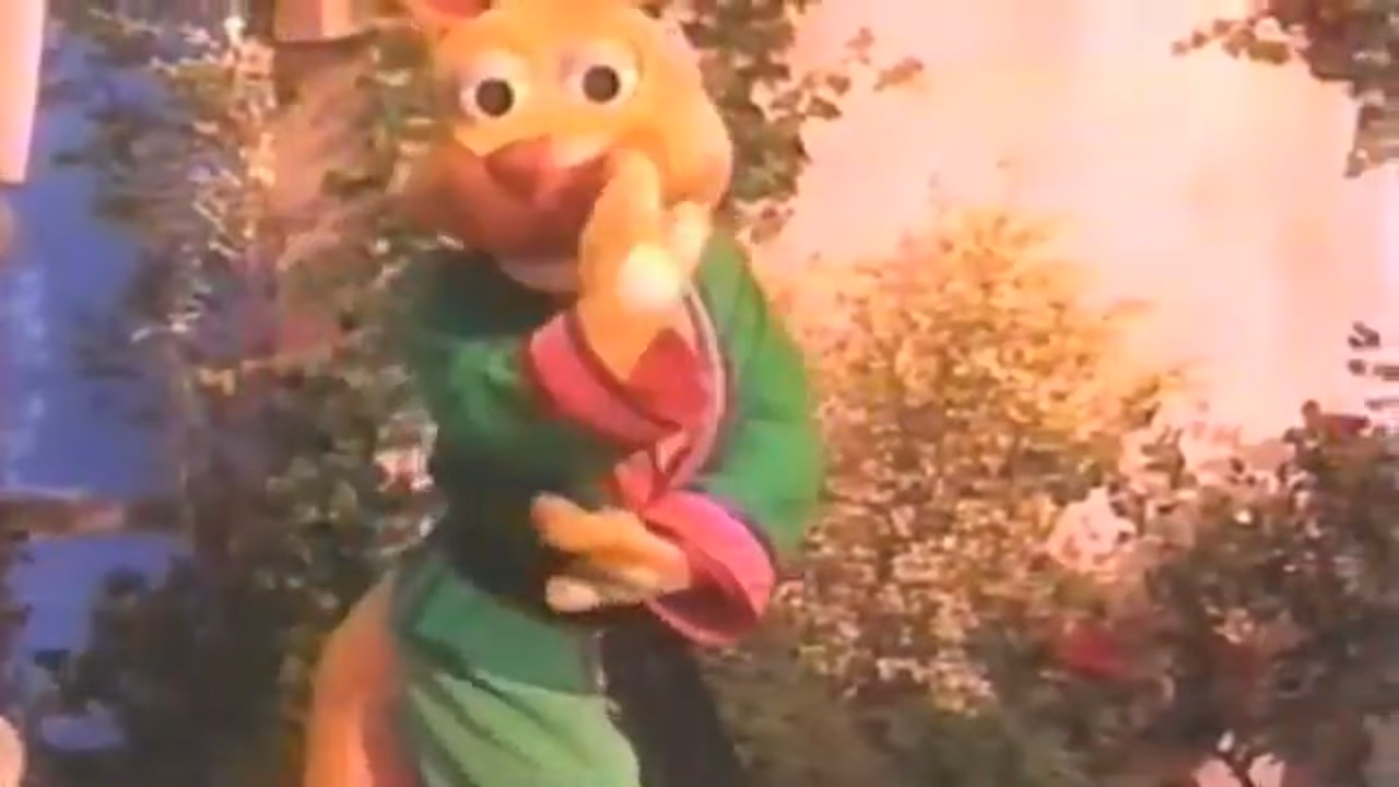 A KangaRoddy puppet performing a dance number in a garden set